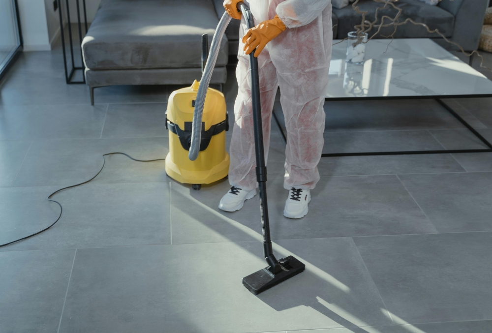 professional cleaner in protective gear cleaning the floor