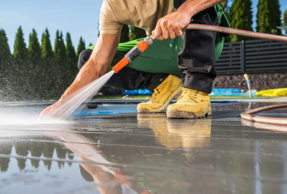 professional cleaner power washing concrete floor